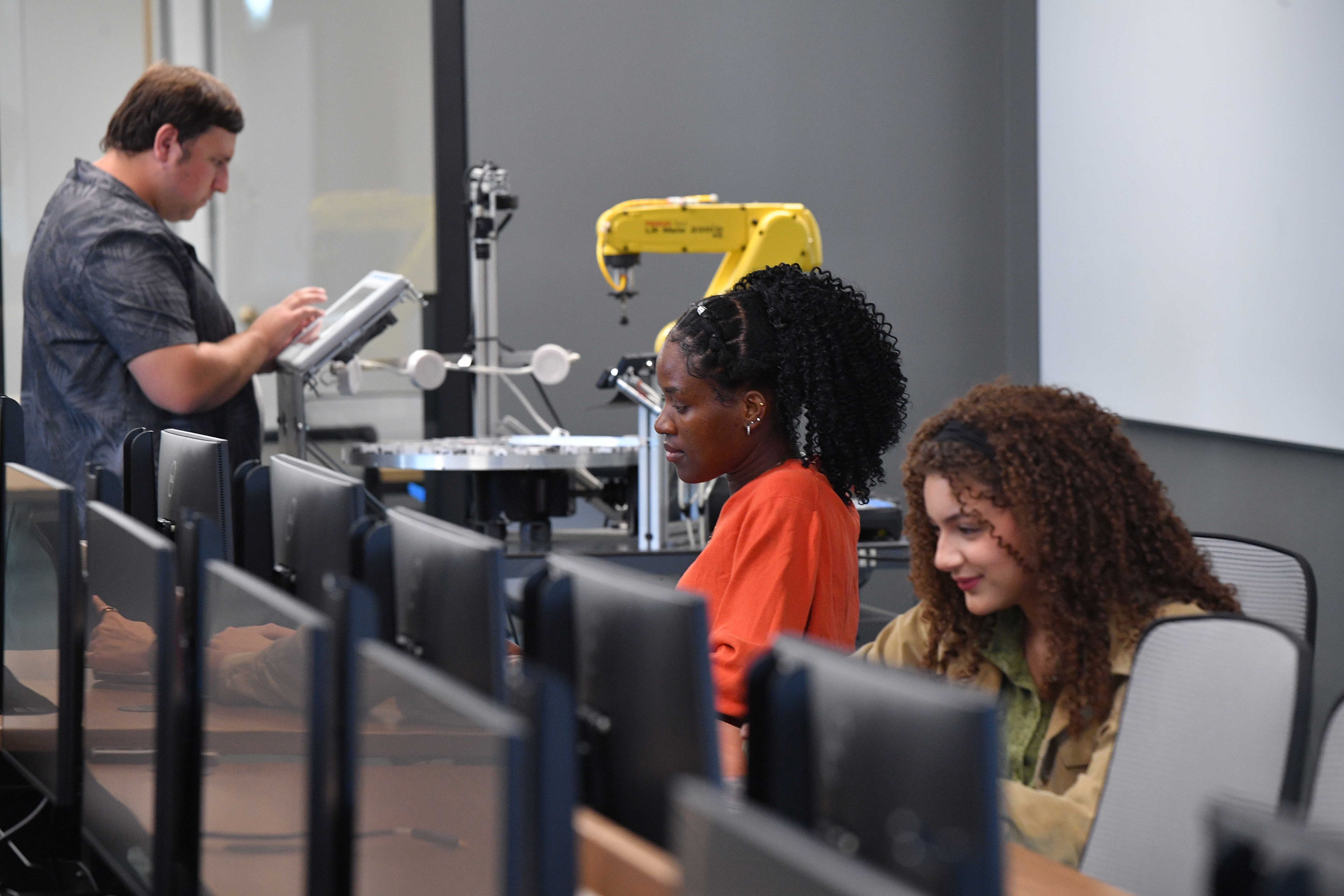 Two students having a conversation in an AI lab