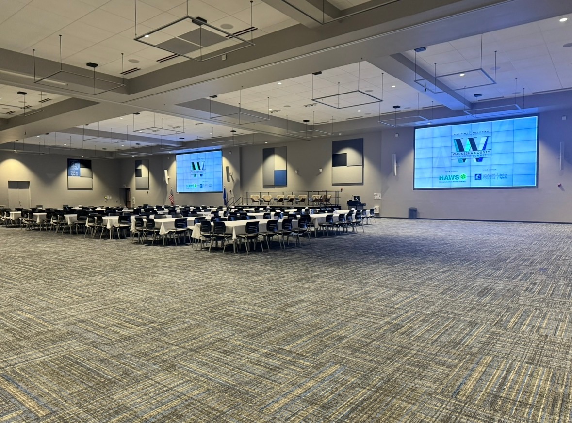 WCTC Anthony J. Natalizio Center with large screens and several tables with chairs