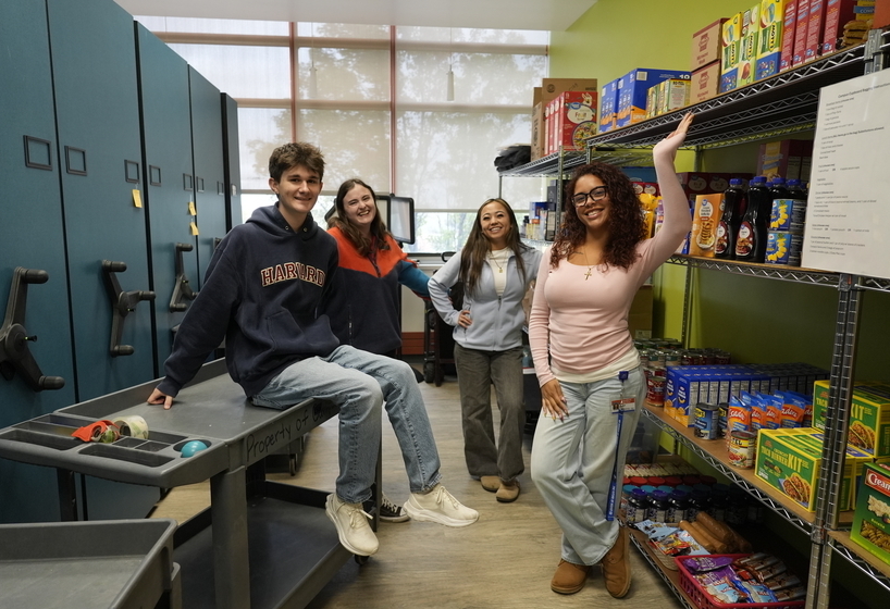 four students standing in the Campus Cupboard