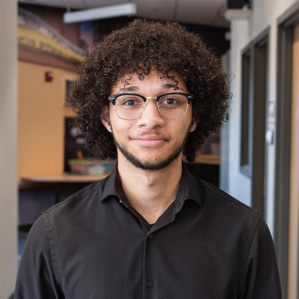 Headshot image of Dylan Holmes.