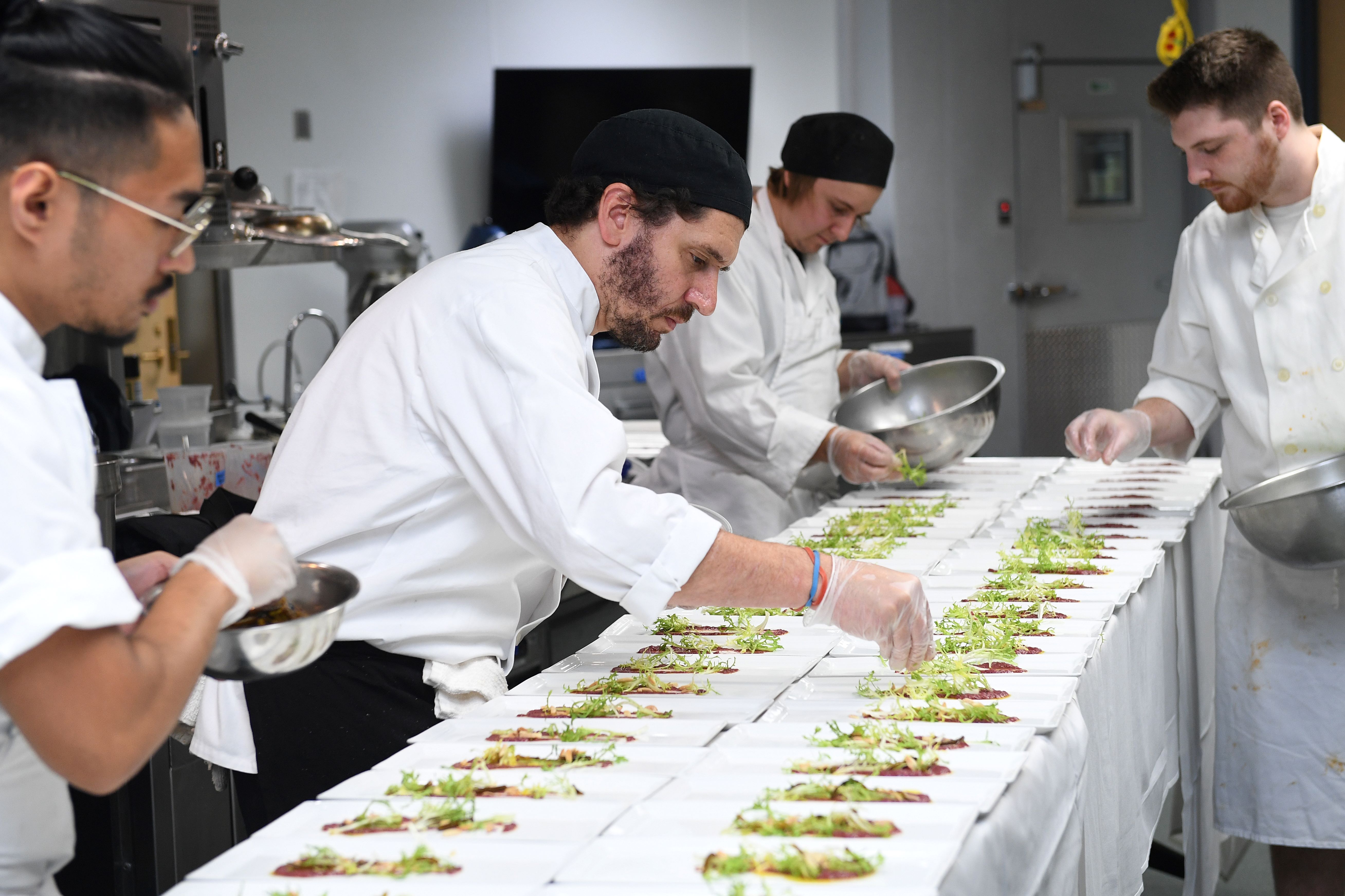 chef spotlight preparing food in culinary kitchen