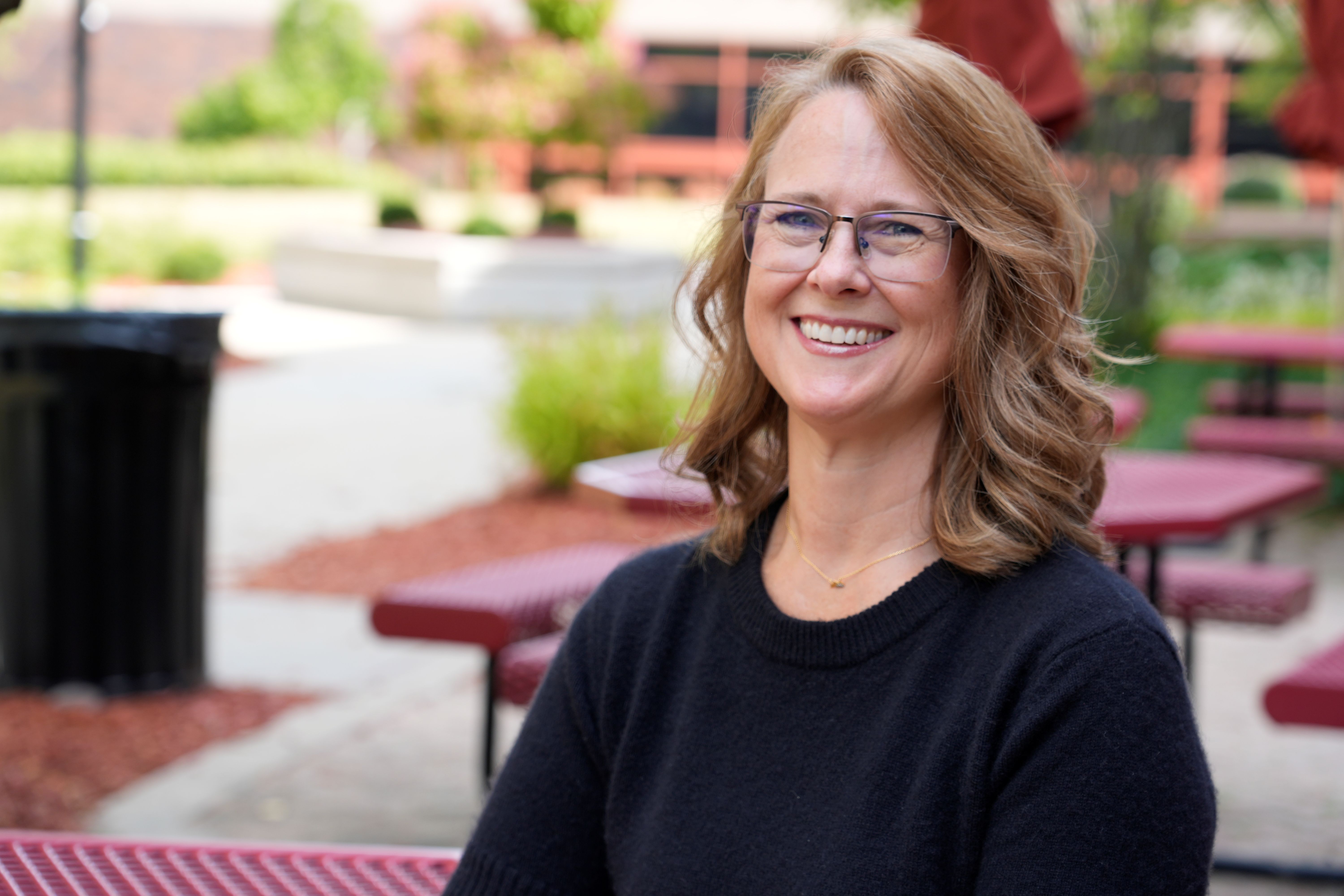 woman sitting at a table smiling