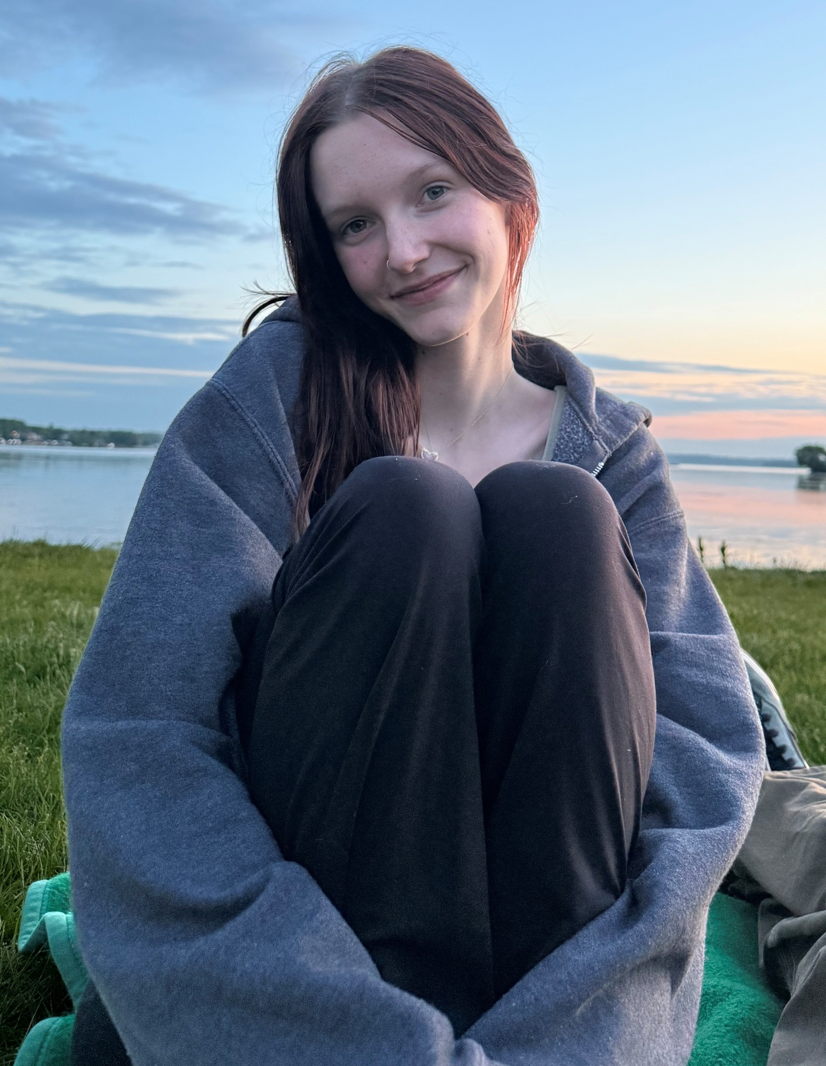Young woman sitting in sun