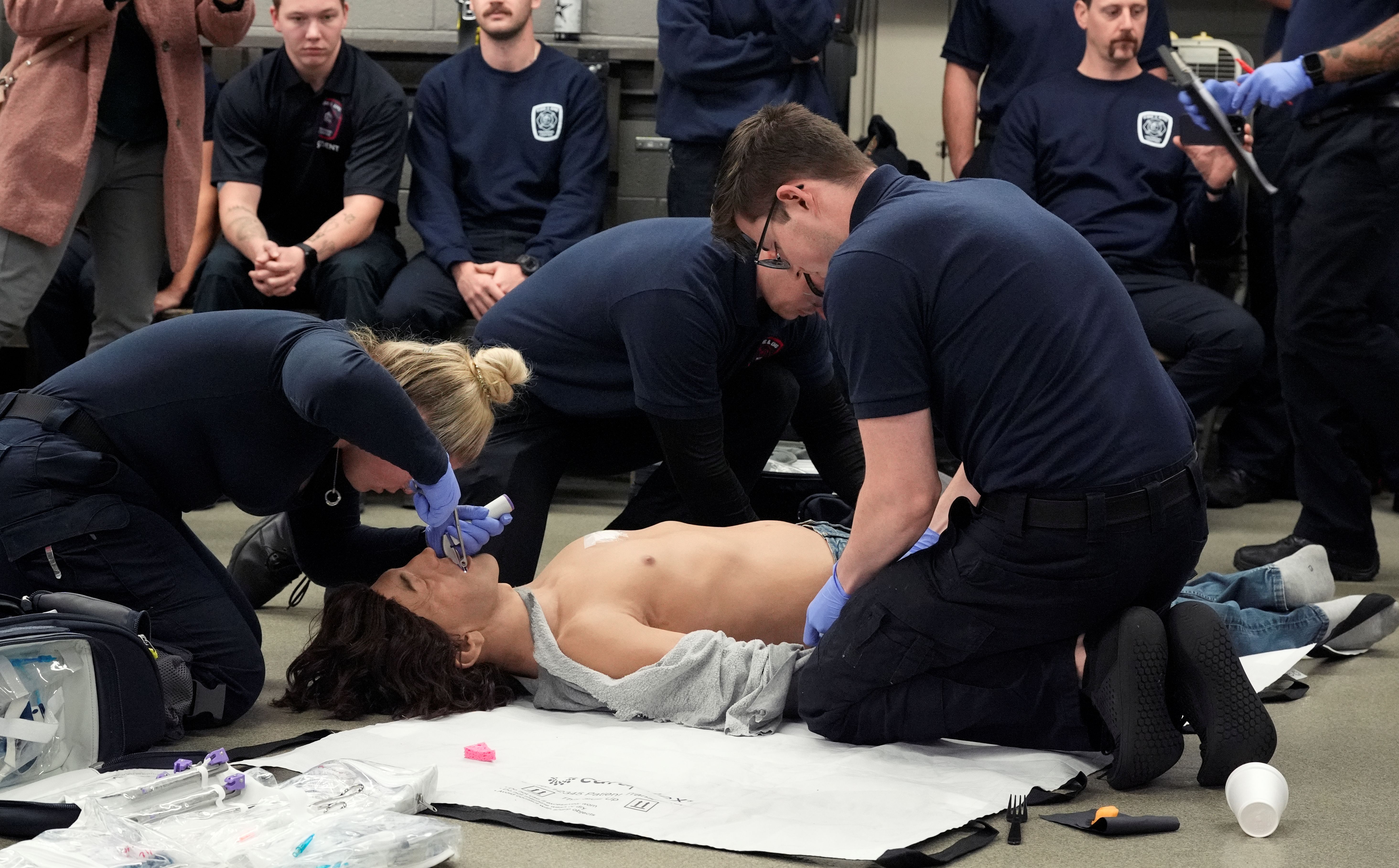 Group of students working on training manikins