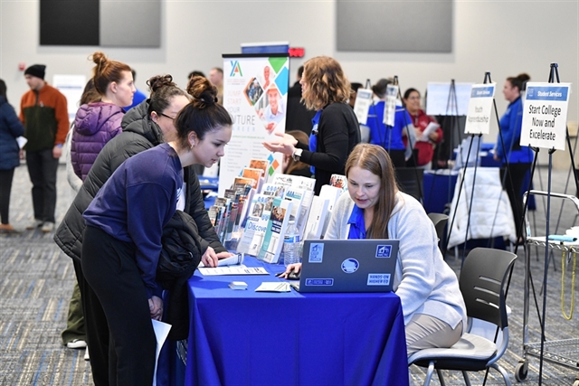 Open House event attendees at tables