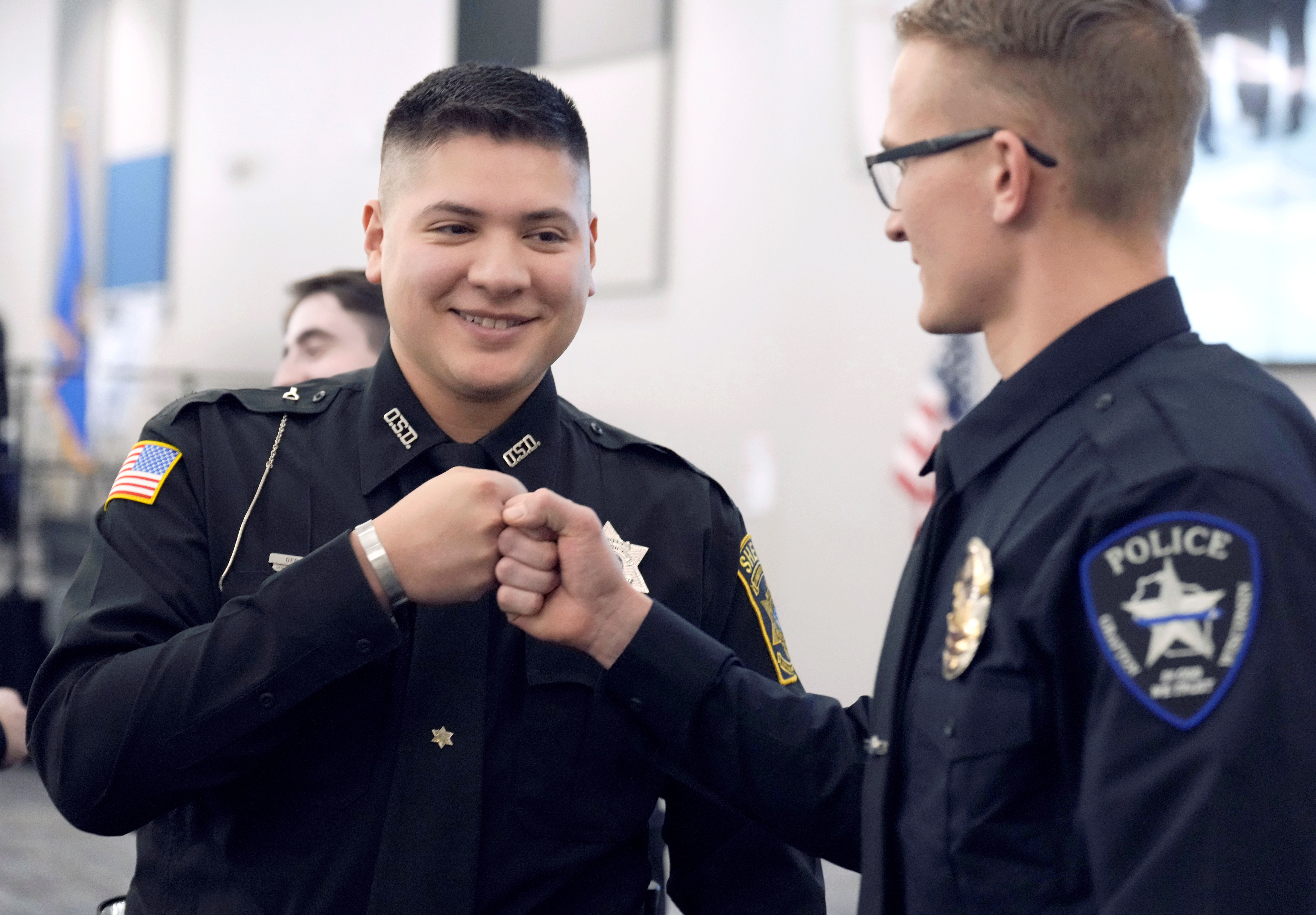 academy student and officer celebrate