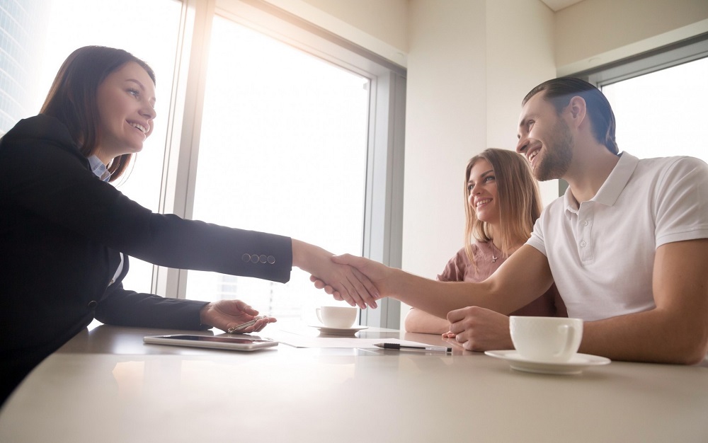 Business person shaking hands with clients