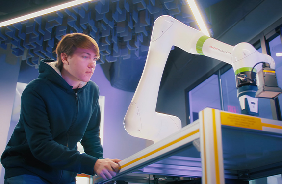 Student with robot in WCTC AI lab